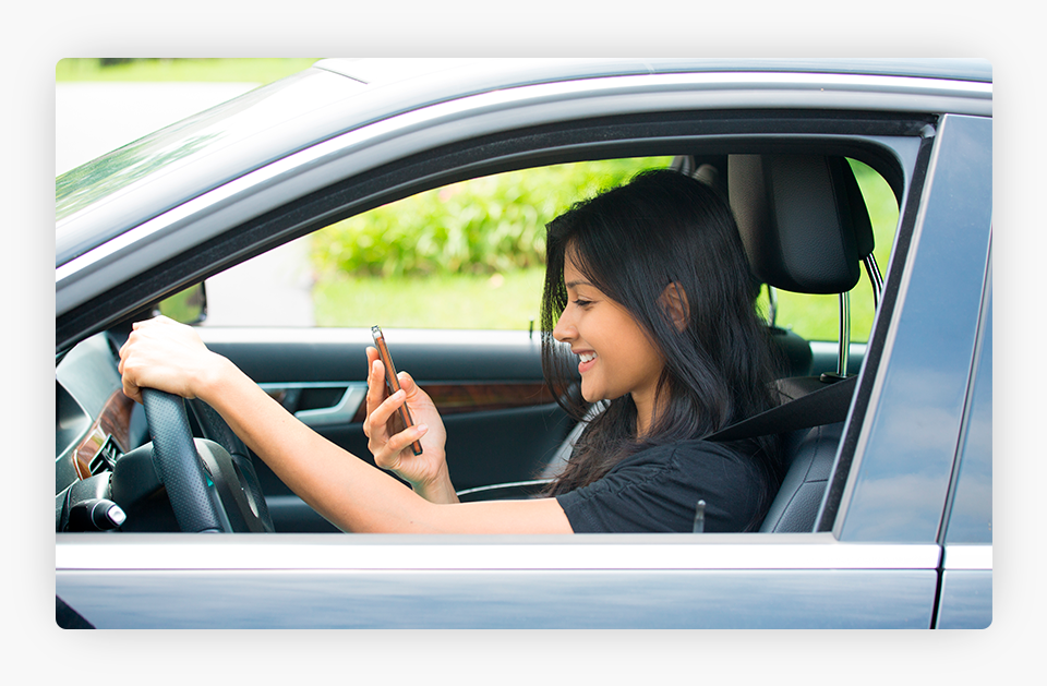 Woman Texting on the Phone While Driving
