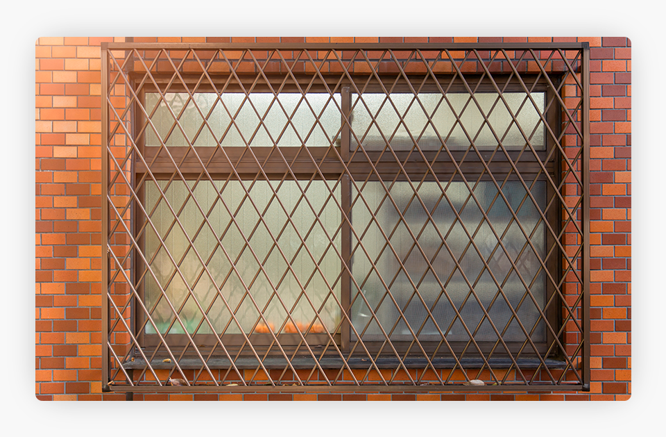 A window guard metal and a brick wall