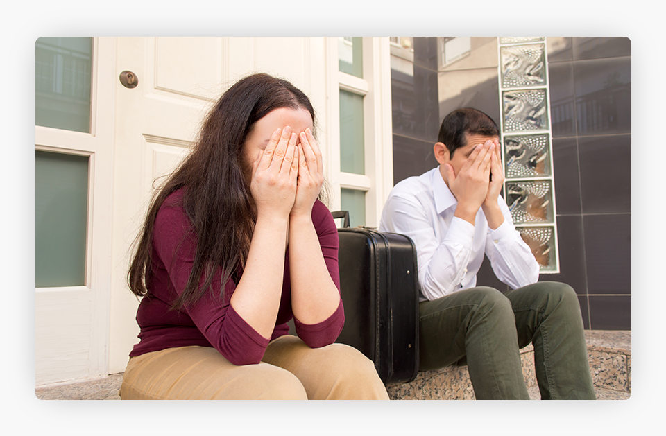 couple sitting crying in doorway