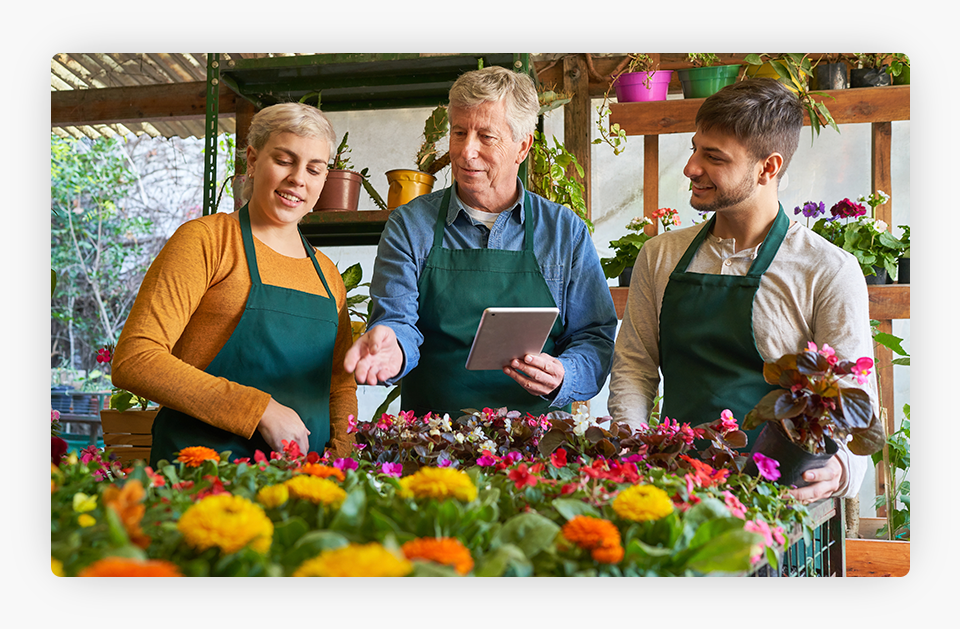 A nursery owner training employees.