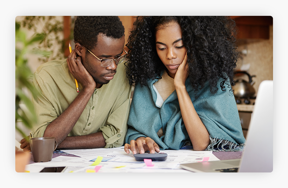 A worried couple is reviewing their finances.