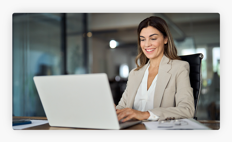 Woman smiling at a computer