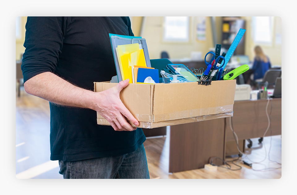 Fired worker holding a box with his belongings