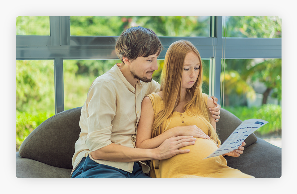 Expectant Couple Reviewing Blood Tests Results