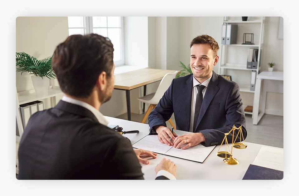 Two suited males talking with each other.